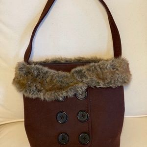 Brown bucket purse with fur trim and handle
